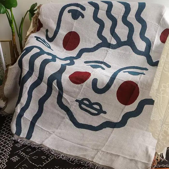 Textile City Couverture à pampilles avec visage abstrait