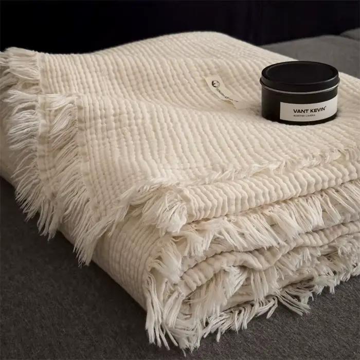 Plaid en tricot épais avec décorations à pompons pour canapé